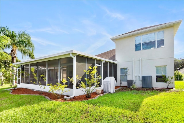 back of property featuring a yard, central AC unit, and a sunroom