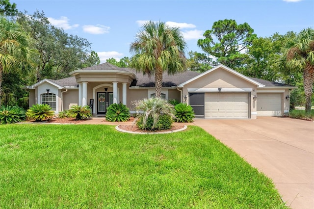 view of front of property featuring a front lawn and a garage