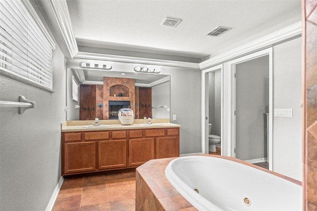 bathroom with vanity, toilet, crown molding, and a relaxing tiled tub