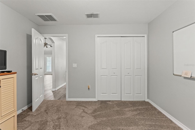 unfurnished bedroom featuring a closet and carpet flooring