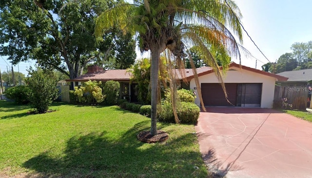 single story home featuring a front lawn and a garage