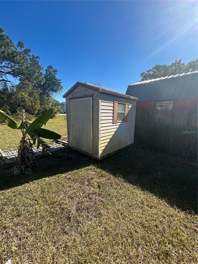 view of outdoor structure featuring a lawn