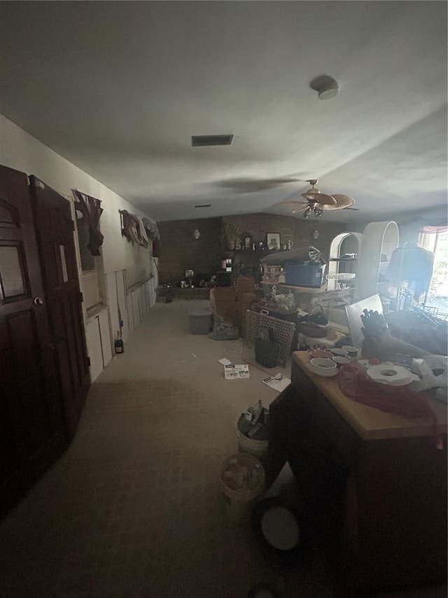 miscellaneous room with ceiling fan and carpet