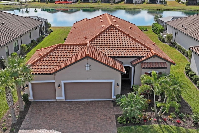 view of front of home featuring a garage and a water view