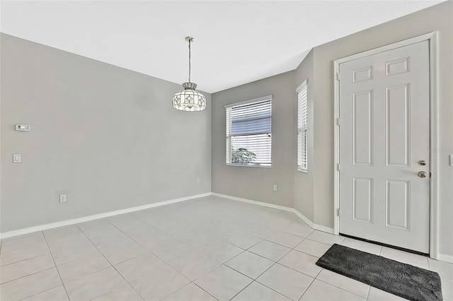 entrance foyer featuring light tile patterned flooring and a chandelier