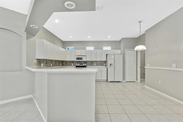 kitchen featuring decorative light fixtures, white cabinets, white appliances, light tile patterned flooring, and kitchen peninsula