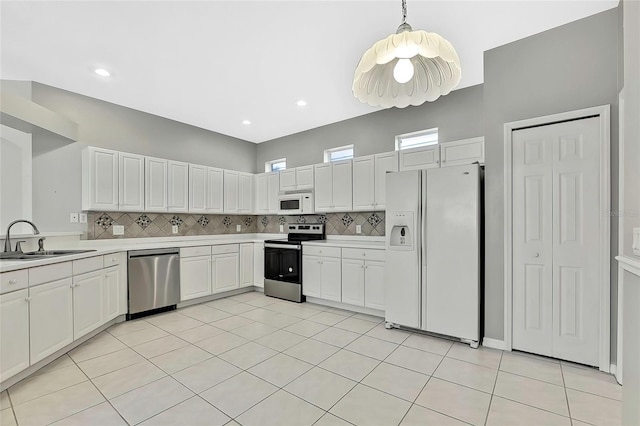 kitchen with sink, white cabinetry, pendant lighting, and appliances with stainless steel finishes