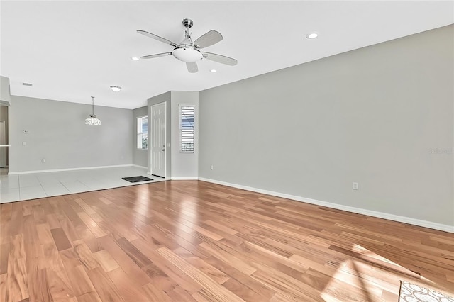 empty room featuring ceiling fan and light hardwood / wood-style flooring