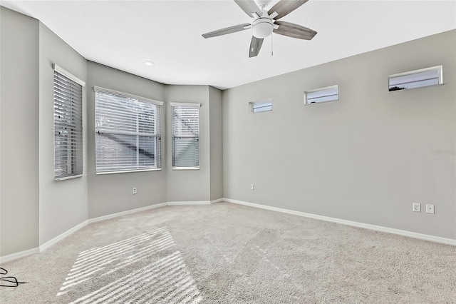 carpeted spare room with ceiling fan