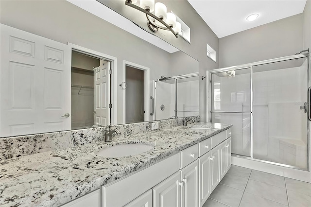 bathroom featuring an enclosed shower, vanity, and tile patterned floors