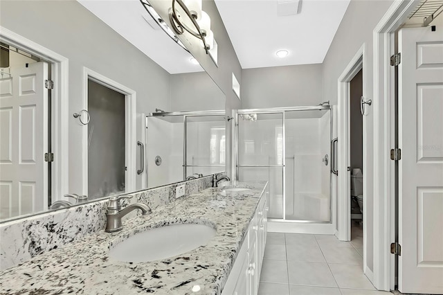 bathroom featuring vanity, an enclosed shower, tile patterned floors, and toilet