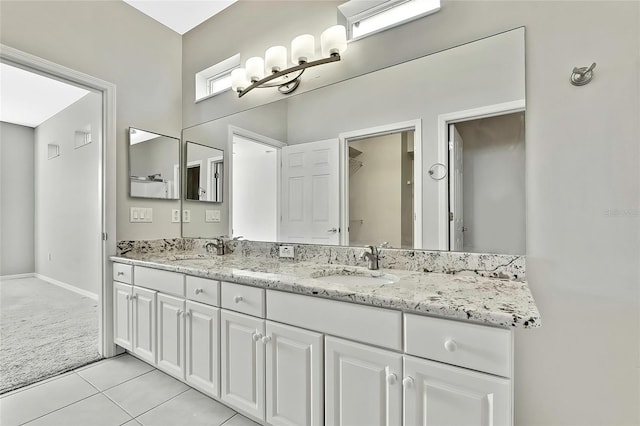 bathroom with tile patterned flooring and vanity