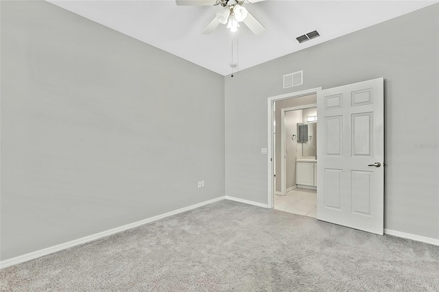 carpeted spare room featuring ceiling fan