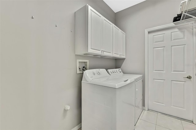 clothes washing area with cabinets, separate washer and dryer, and light tile patterned floors