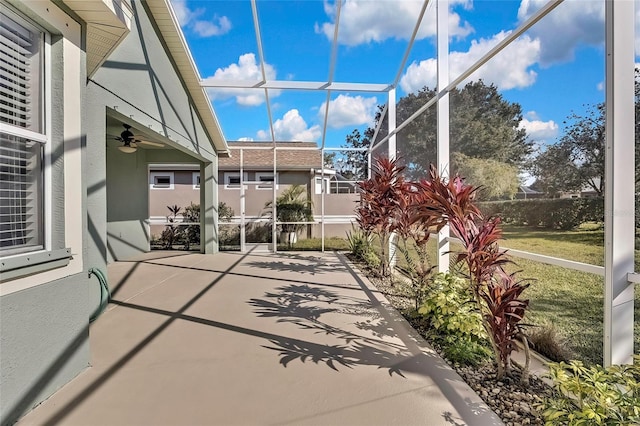 view of patio / terrace with ceiling fan and a lanai