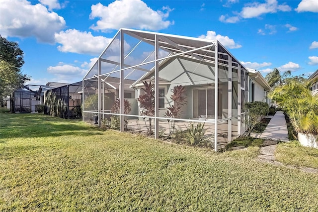 rear view of house featuring glass enclosure and a yard