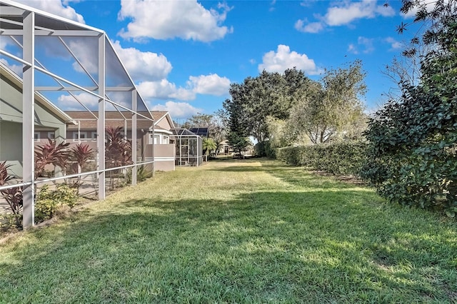 view of yard with glass enclosure