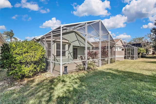 back of property with a lanai and a yard