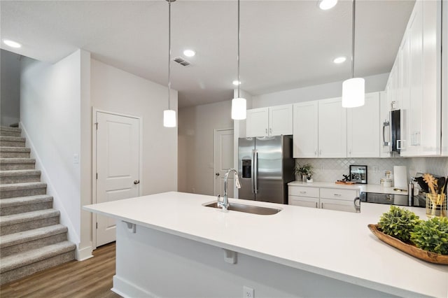 kitchen with sink, dark wood-type flooring, tasteful backsplash, white cabinets, and appliances with stainless steel finishes