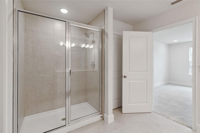 bathroom featuring tile patterned flooring and a shower with door