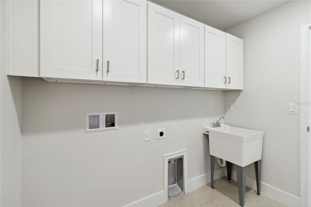 washroom featuring electric dryer hookup, light tile patterned floors, cabinets, and washer hookup