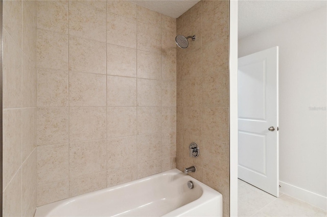 bathroom featuring tile patterned flooring and tiled shower / bath