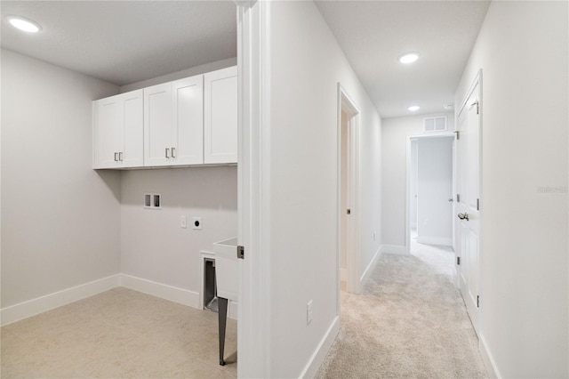 laundry room with electric dryer hookup, cabinets, light colored carpet, and hookup for a washing machine