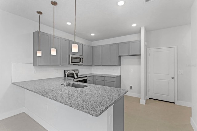 kitchen featuring decorative light fixtures, gray cabinets, kitchen peninsula, and appliances with stainless steel finishes