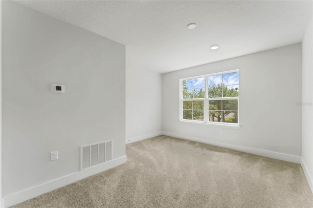 unfurnished room with carpet floors and a textured ceiling