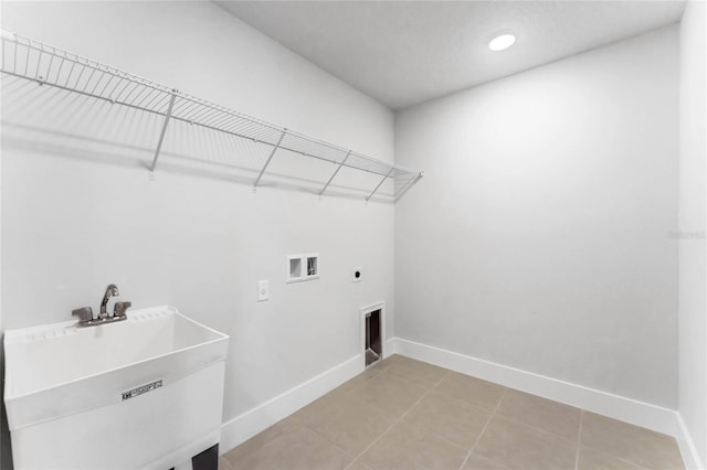 laundry room with washer hookup, electric dryer hookup, sink, and tile patterned floors