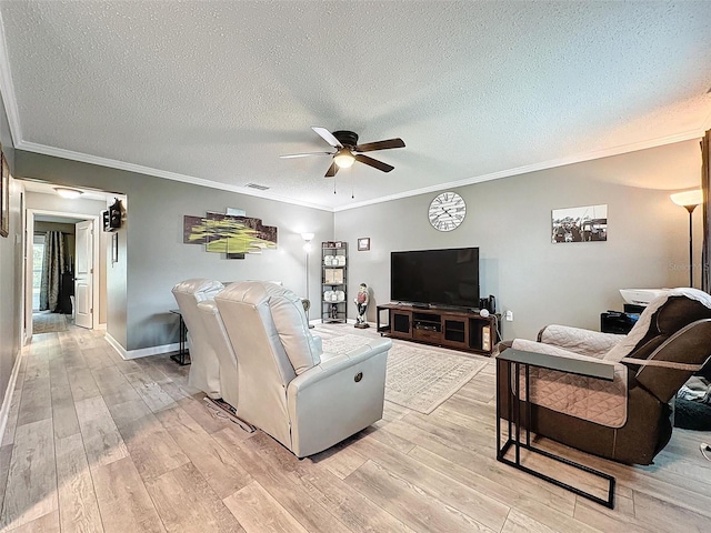 living room with a textured ceiling, light wood-type flooring, ceiling fan, and ornamental molding