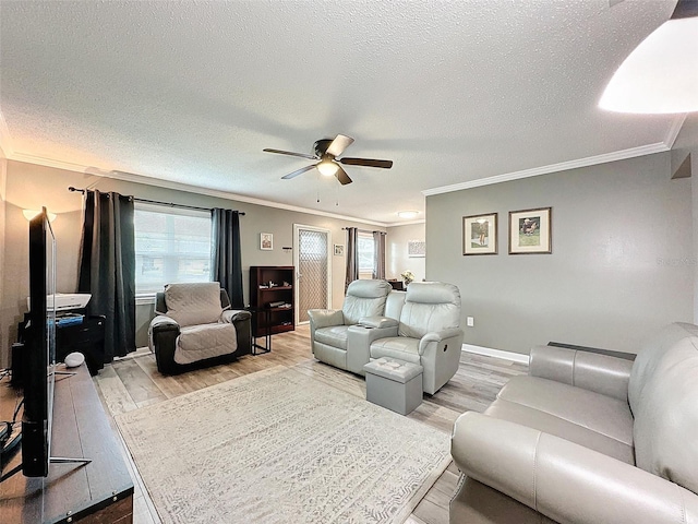 living room with hardwood / wood-style flooring, ceiling fan, ornamental molding, and a textured ceiling