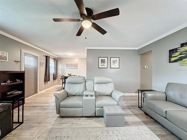 living room featuring light hardwood / wood-style flooring, ceiling fan, and ornamental molding