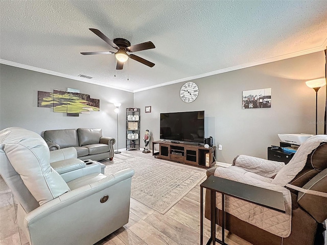 living room with a textured ceiling, light hardwood / wood-style floors, ceiling fan, and ornamental molding