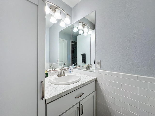 bathroom featuring vanity and tile walls