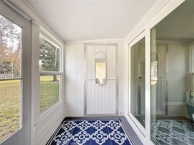 sunroom featuring a wealth of natural light and lofted ceiling