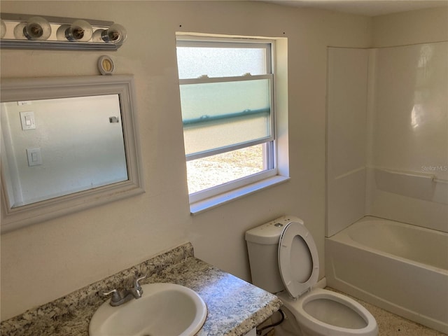 full bathroom with vanity, a healthy amount of sunlight, toilet, and washtub / shower combination