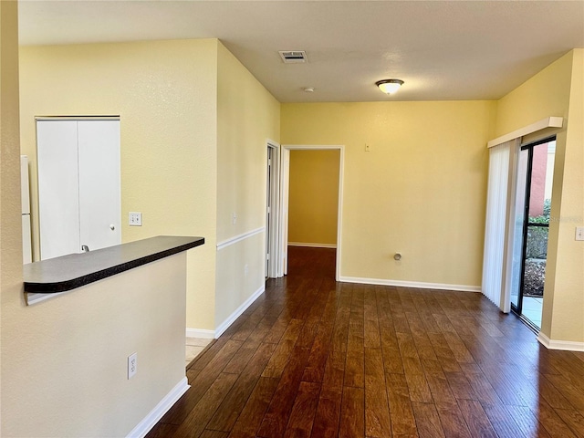 unfurnished room featuring dark hardwood / wood-style flooring