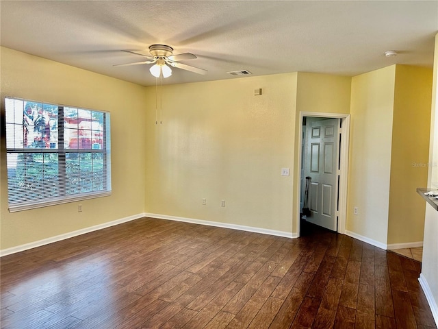 empty room featuring dark hardwood / wood-style floors and ceiling fan