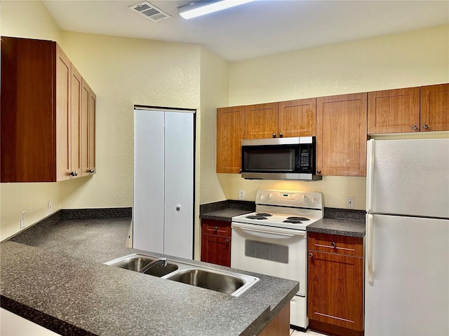 kitchen featuring white appliances and sink