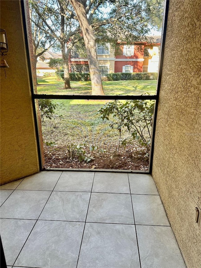 doorway to outside with tile patterned flooring