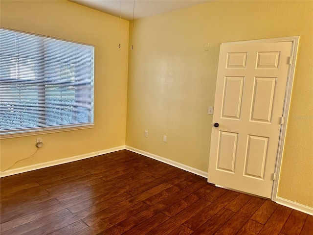 spare room featuring dark hardwood / wood-style flooring