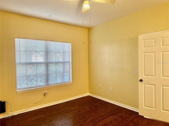 empty room featuring ceiling fan and dark wood-type flooring