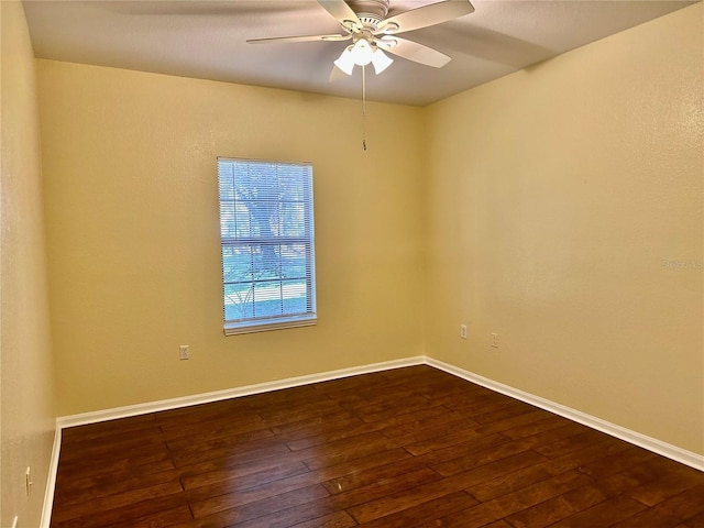 spare room featuring ceiling fan and dark hardwood / wood-style flooring