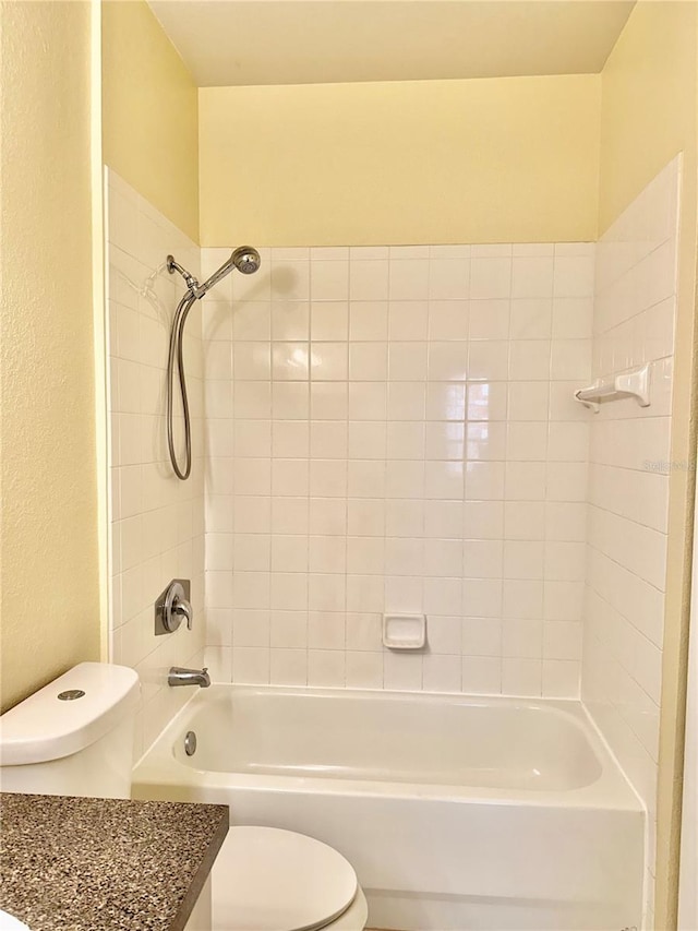 full bathroom featuring vanity, toilet, and tiled shower / bath