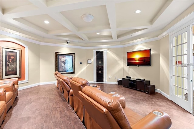 home theater room with hardwood / wood-style floors and crown molding