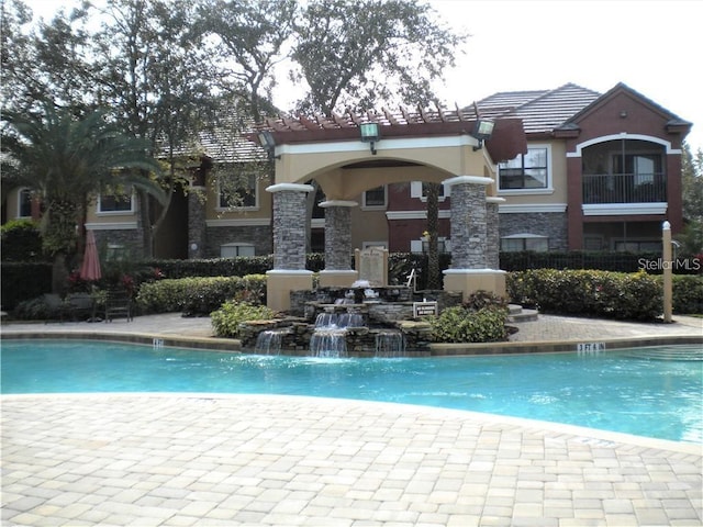 view of swimming pool featuring pool water feature