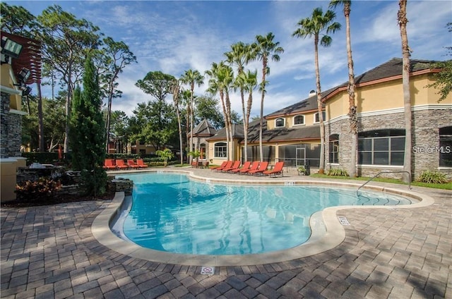 view of swimming pool with a patio