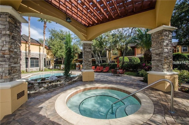 view of swimming pool with a patio area and a hot tub