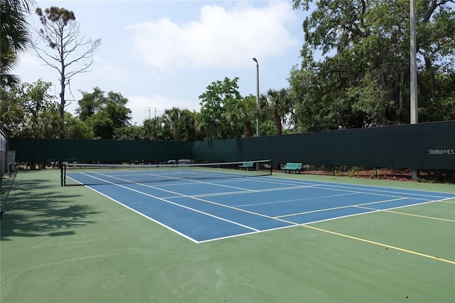 view of tennis court featuring basketball hoop